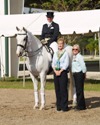 Jodie Kelly and Manhattan receive ribbon and congratulations for finishing 4th in the FEI Grand Prix Championship in the Open Division